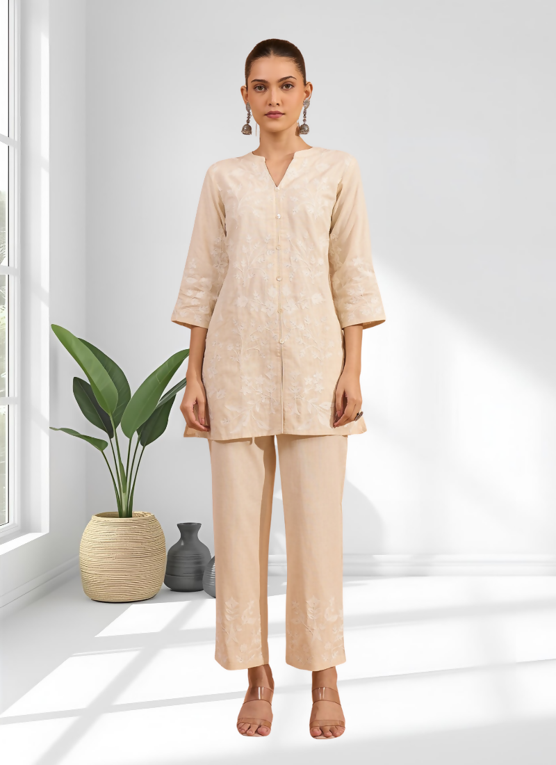 Cream linen cord set with embroidery and a modern split V-neckline.
