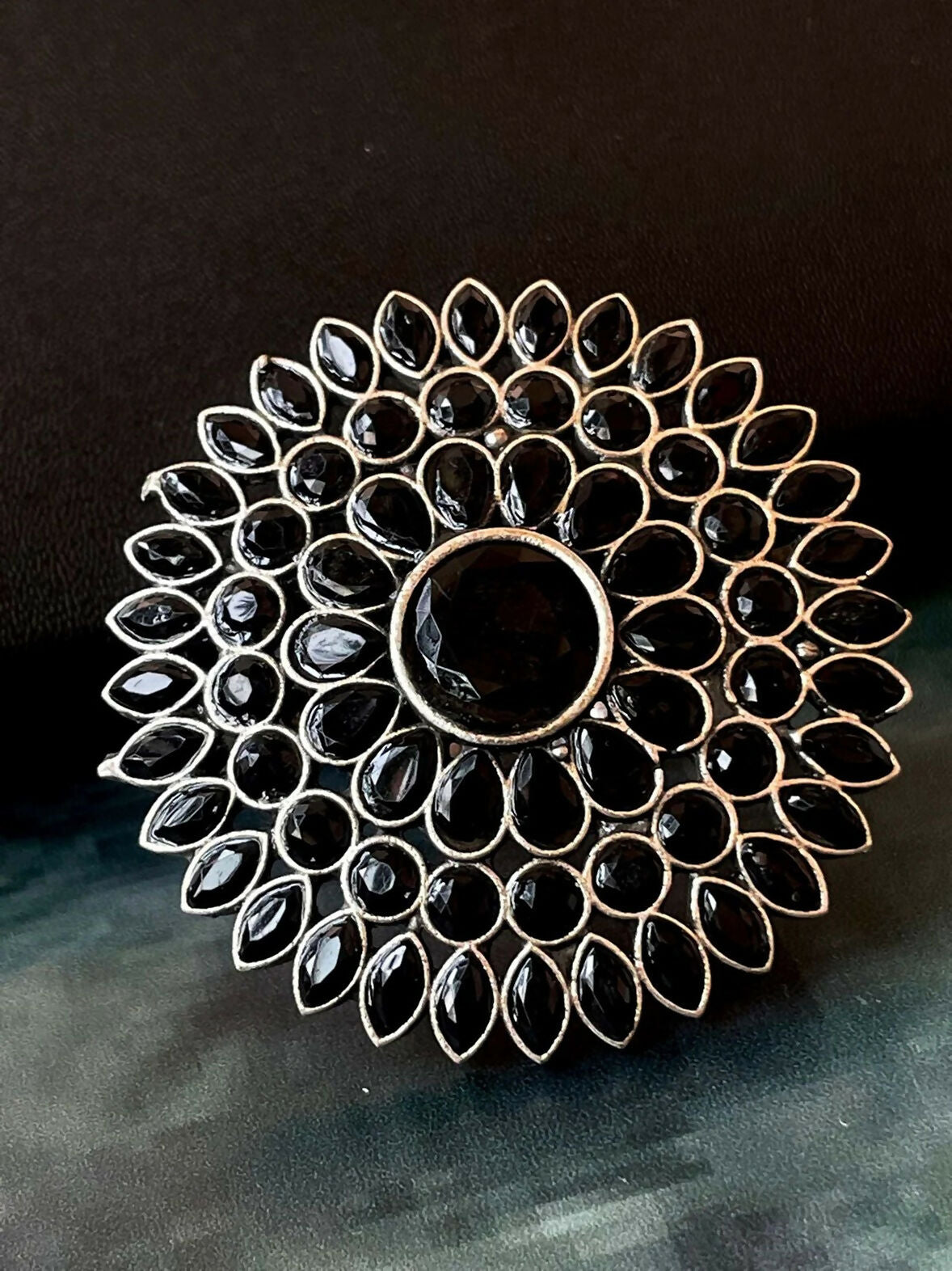 Oversized bohemian statement ring featuring a black cabochon Monalisa stone in an antiqued silver-tone brass setting.