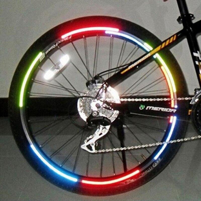 Fluorescent reflective stickers applied to bicycle wheel spokes for night visibility