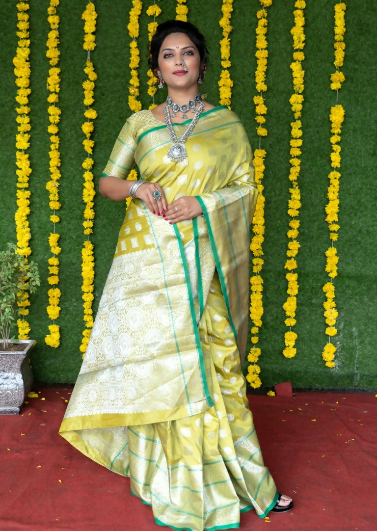 Elegant green soft handloom silk saree with gold zari woven details and matching blouse