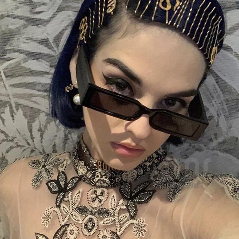 Model wearing 90s style narrow rectangular vintage sunglasses with thick frames