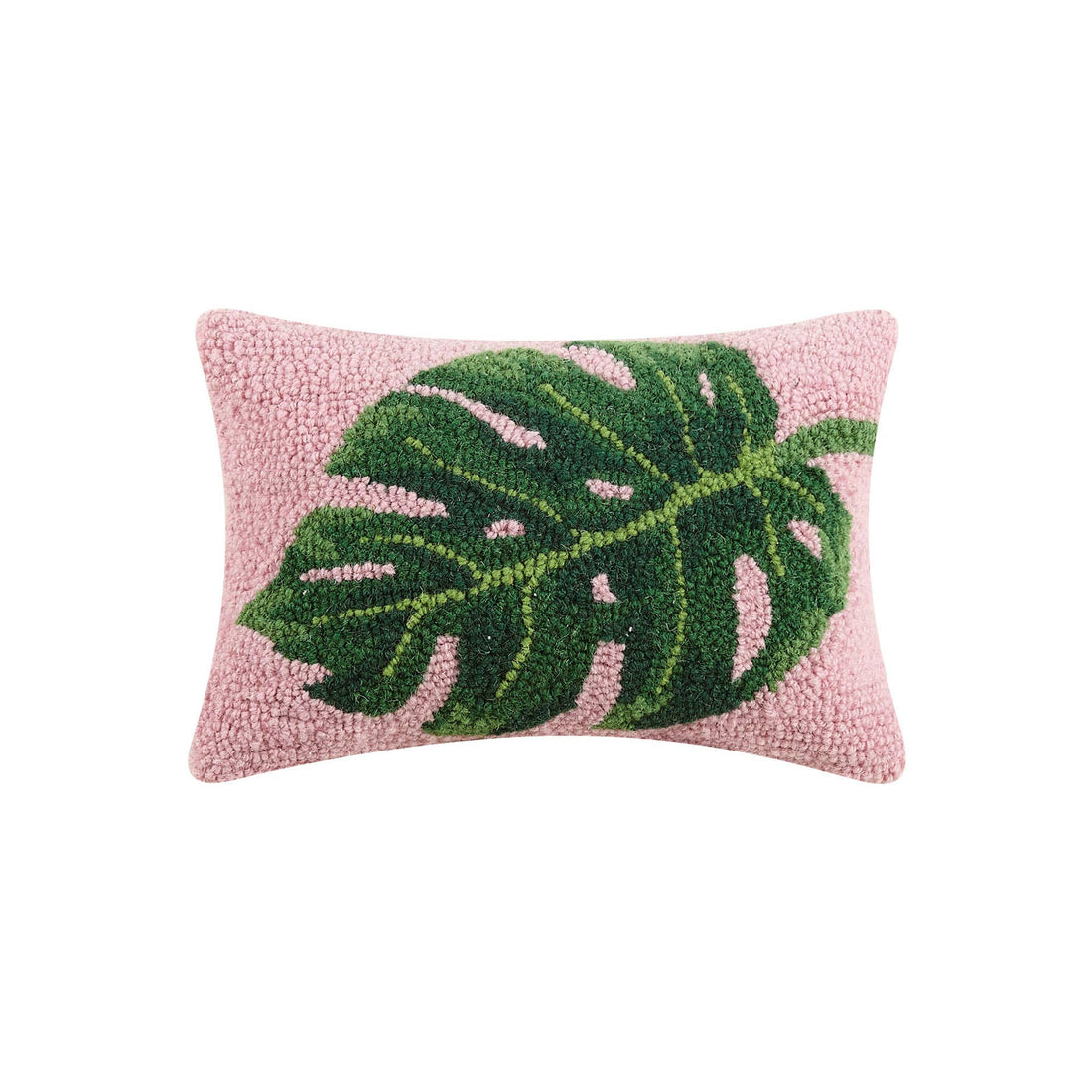 Close up of 12x20 inch palm leaf hook pillow with vibrant pink background and green botanical design on a sofa