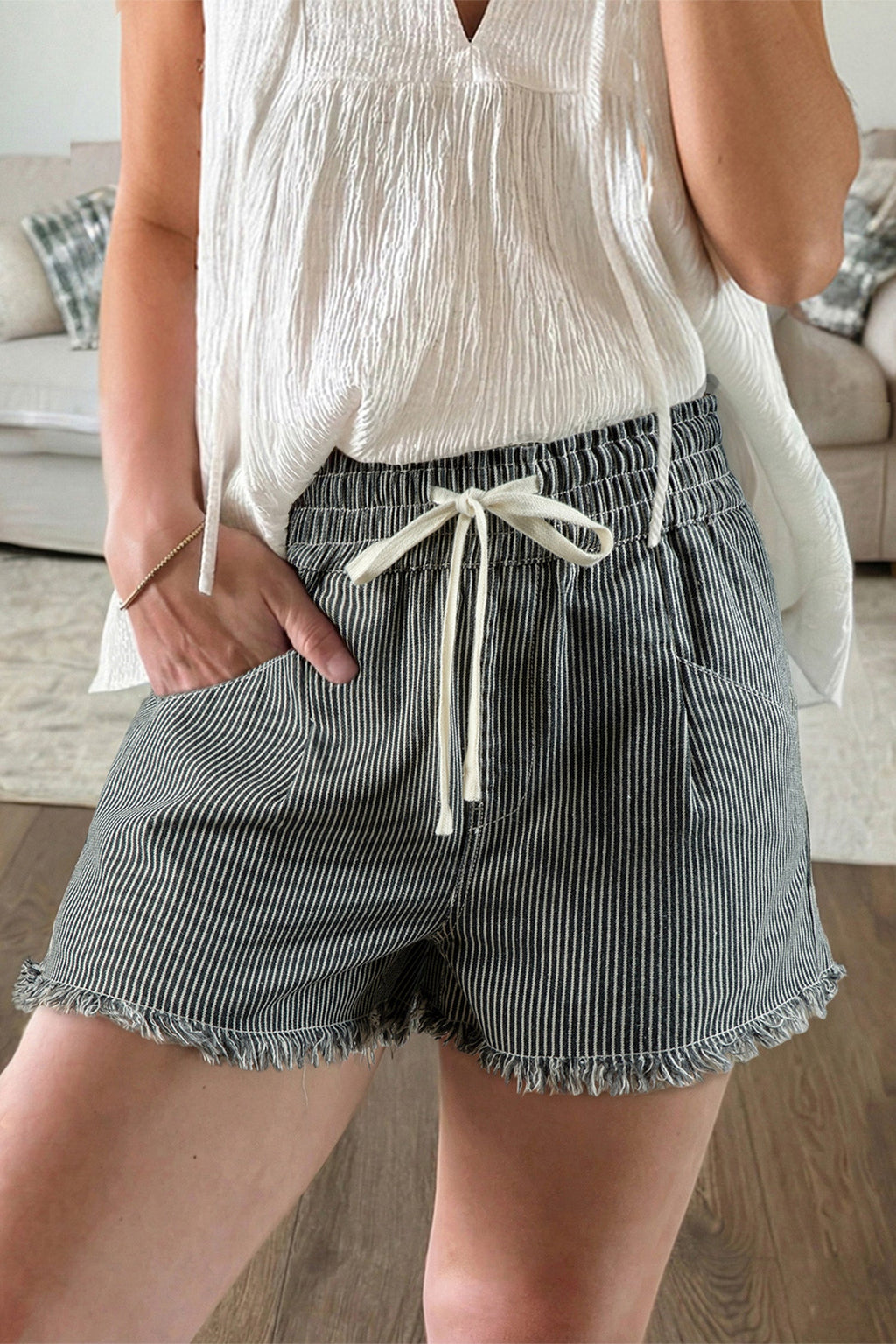 Model wearing Campbell striped elastic waist casual shorts with a high rise and raw edge hem in a weekend lifestyle setting.