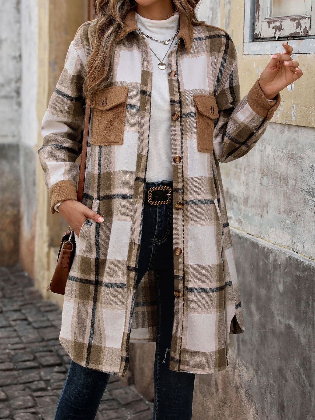 A stylish plaid button-up long sleeve coat featuring side slits and front pockets.