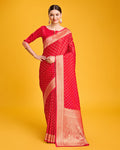 Deep red Banarasi satin silk saree with heavy zari brocade embellishments.