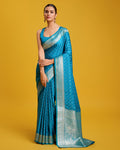 A beautiful Cyan Banarasi silk saree with intricate gold Zari woven work and matching blouse fabric.