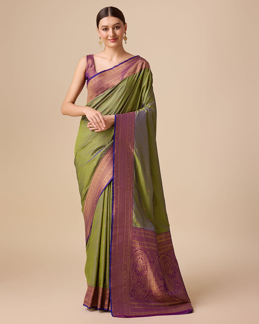 Olive green Banarasi silk saree with detailed zari and brocade patterns.