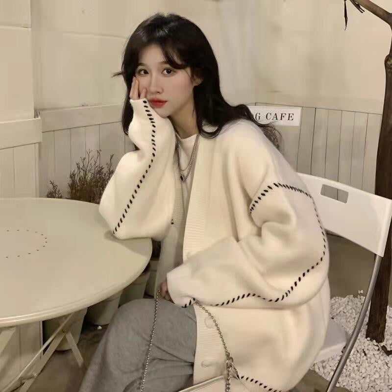 Women's V-neck loose knit cardigan in white or black with contrast stitching, ideal for a college chic or street style look