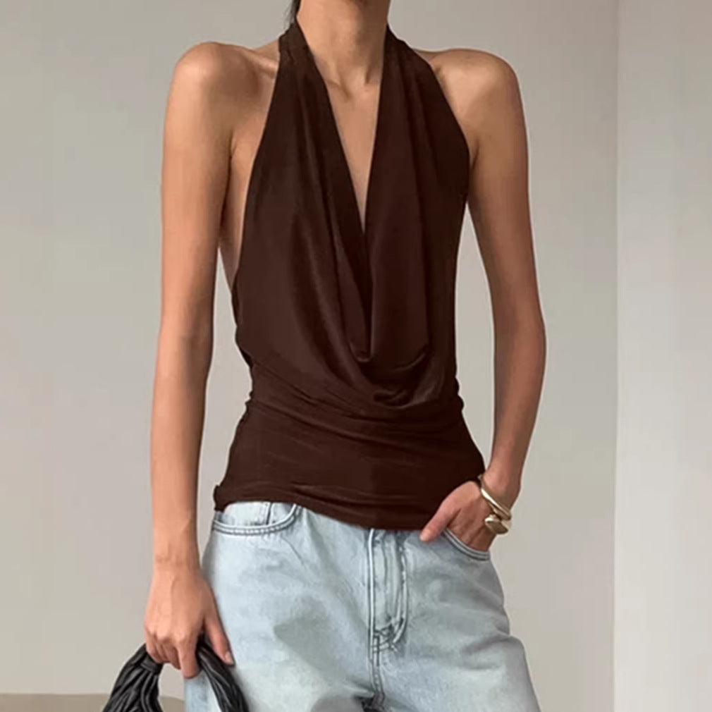 A woman wearing a stylish brown backless halter top with a boat-neck design.
