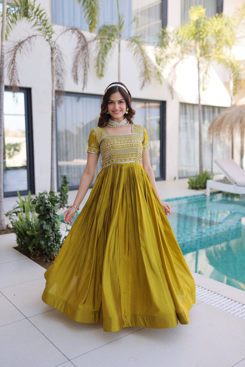 Mehendi green silk floor-length party gown with intricate gold sequins, zari, and pipe bead embroidery.