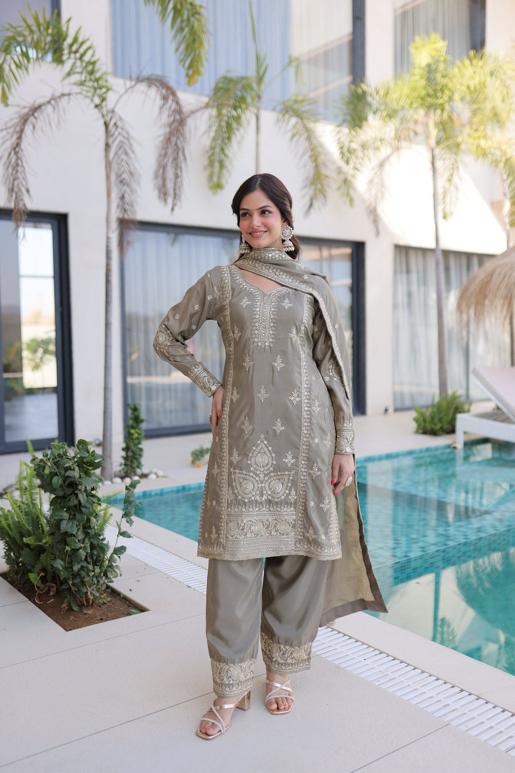 Woman wearing Chiku Ho Silk kurta set with Zari multi-thread embroidery and matching dupatta