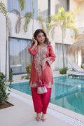 A maroon viscose kurta pant set with intricate sequins, coding zari embroidery, and a matching Batwa bag.