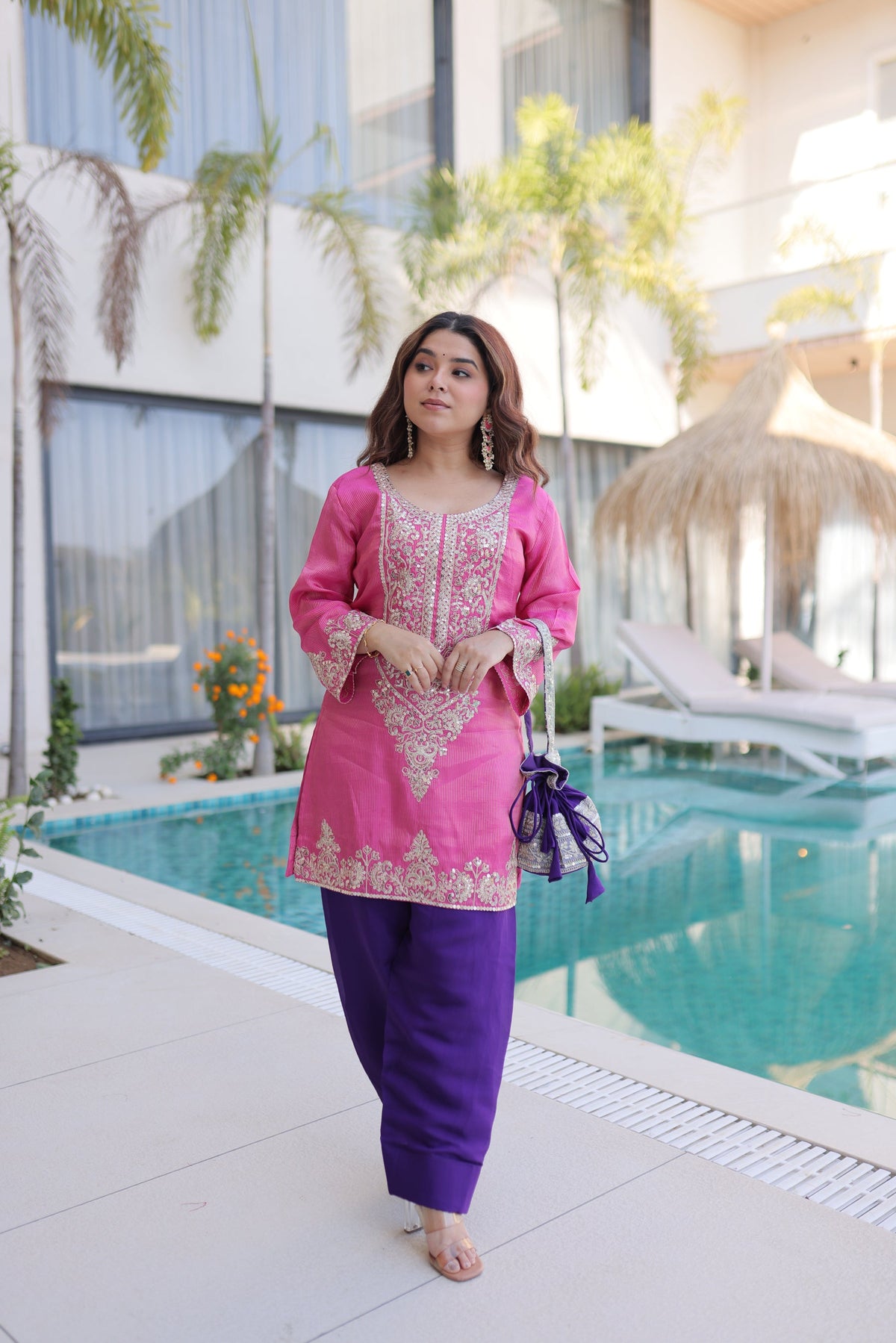 Pink viscose kurta pant set with intricate sequins and coding zari embroidery, including a matching batwa bag.