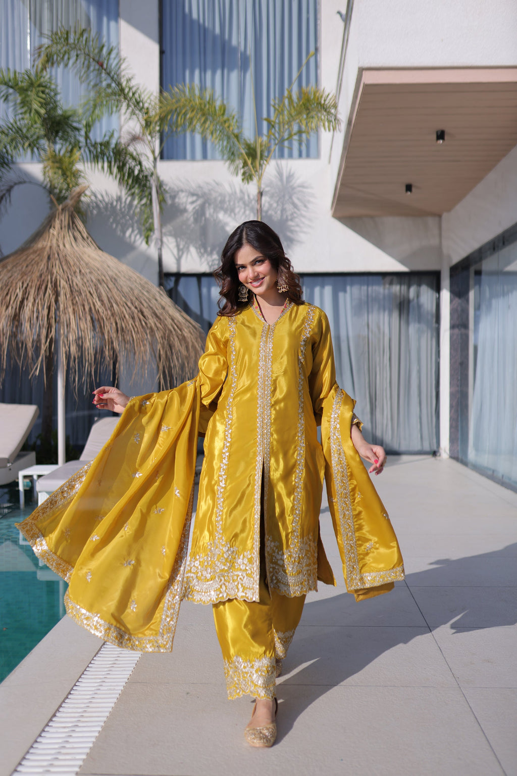 Yellow H O Silk kurta pant set featuring elegant sequins and zari embroidery, paired with a matching dupatta.