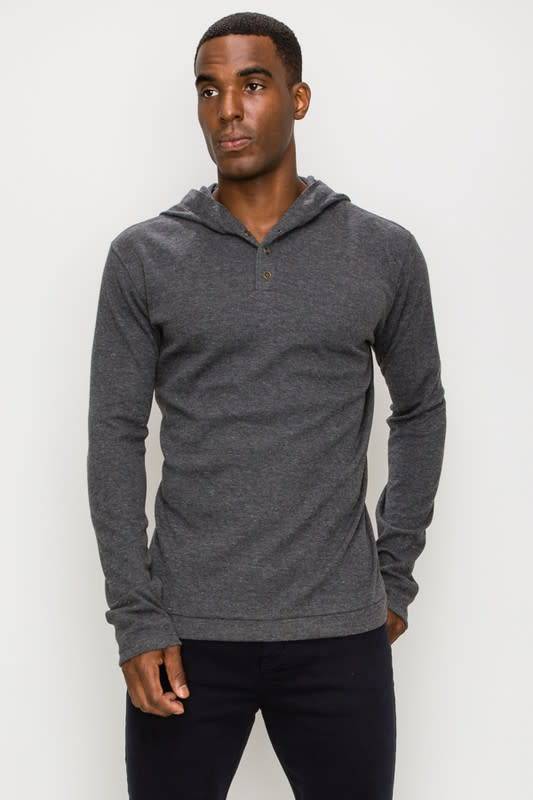 Men wearing a long sleeve charcoal grey henley hooded top with button placket