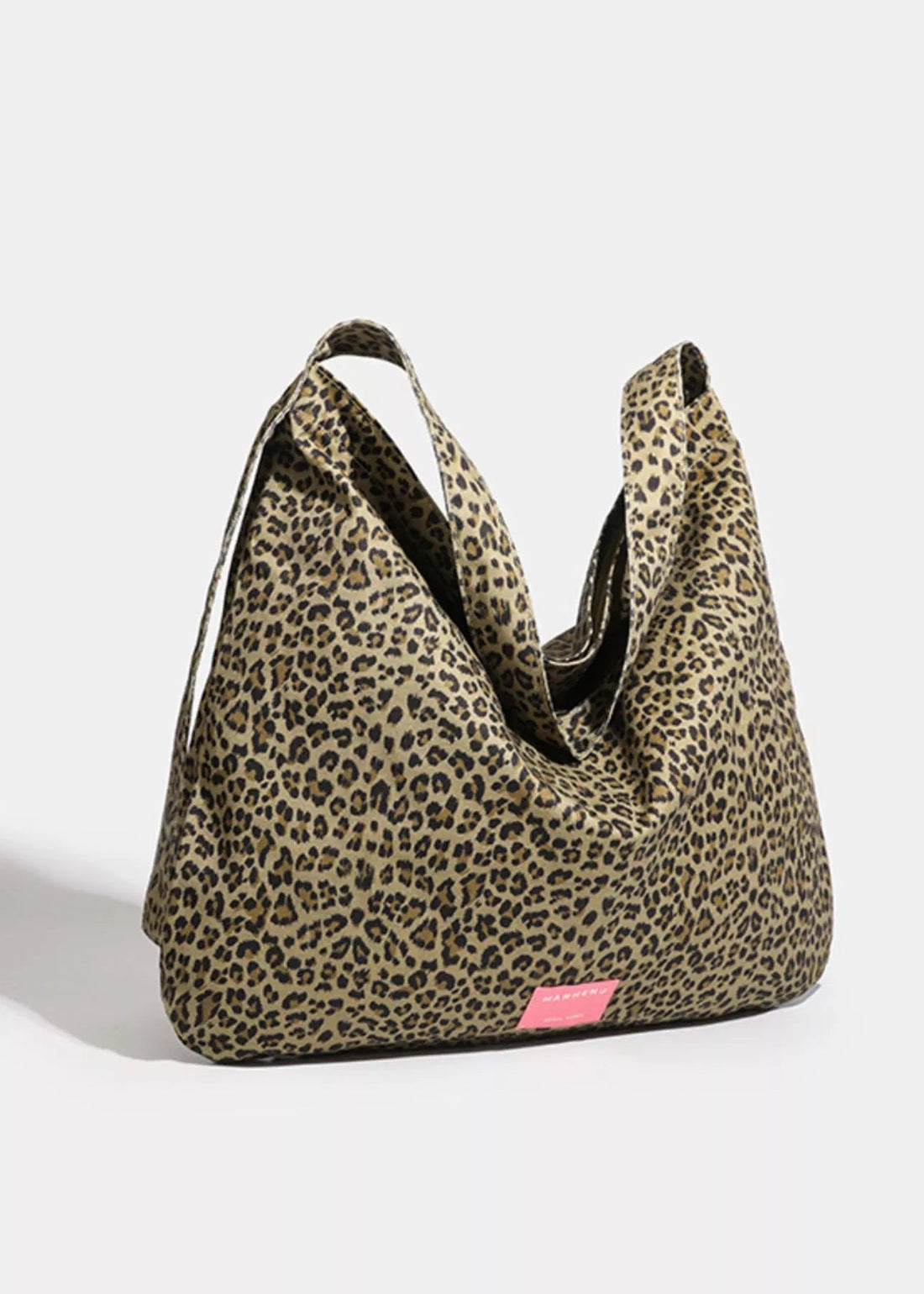 Leopard print bag with a pink tag on a white background