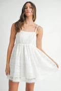Close up of a white eyelet lace babydoll mini cami dress