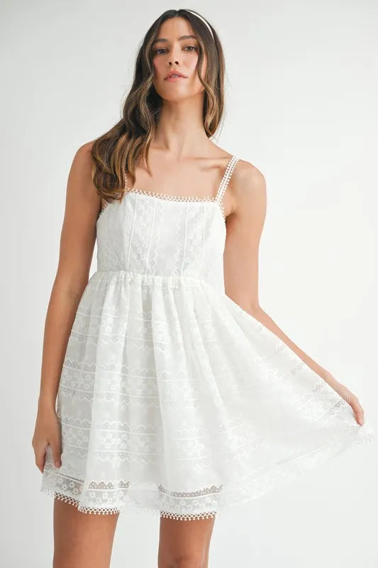 Close up of a white eyelet lace babydoll mini cami dress