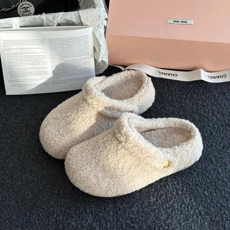 A pair of beige plush fleece-lined closed-toe slippers with a thickened sole shown from a top-down view.
