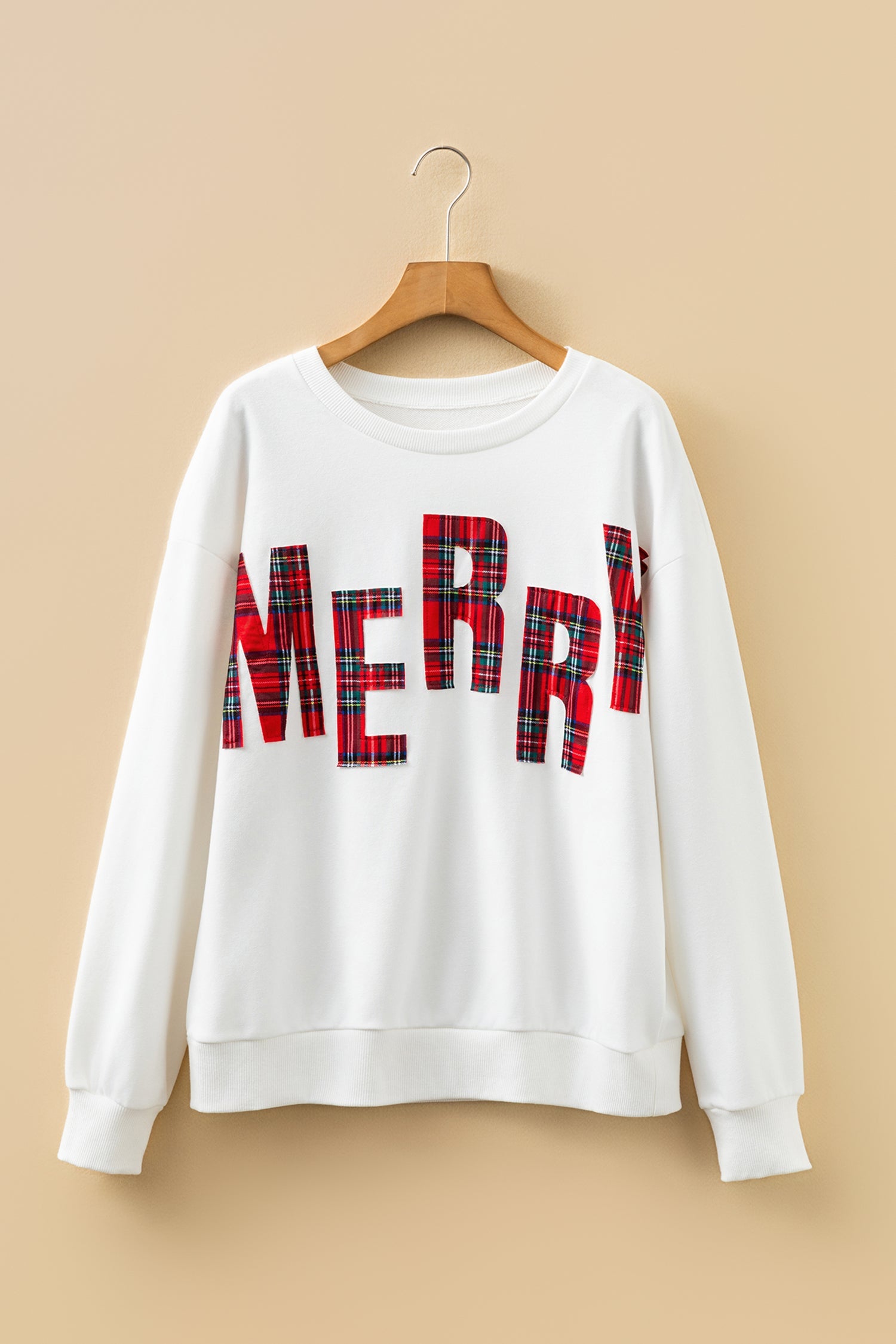 White crewneck sweatshirt with red and green plaid MERRY lettering graphic on front