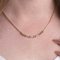 Customized Morse Code name necklace with elegant bead and tube details on a simple chain.