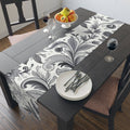 Elegant floral table runner draped over a dining table, styled for a wedding or holiday celebration.