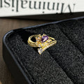 Close up of a retro-style geometric open ring with micro pave detail worn on a finger