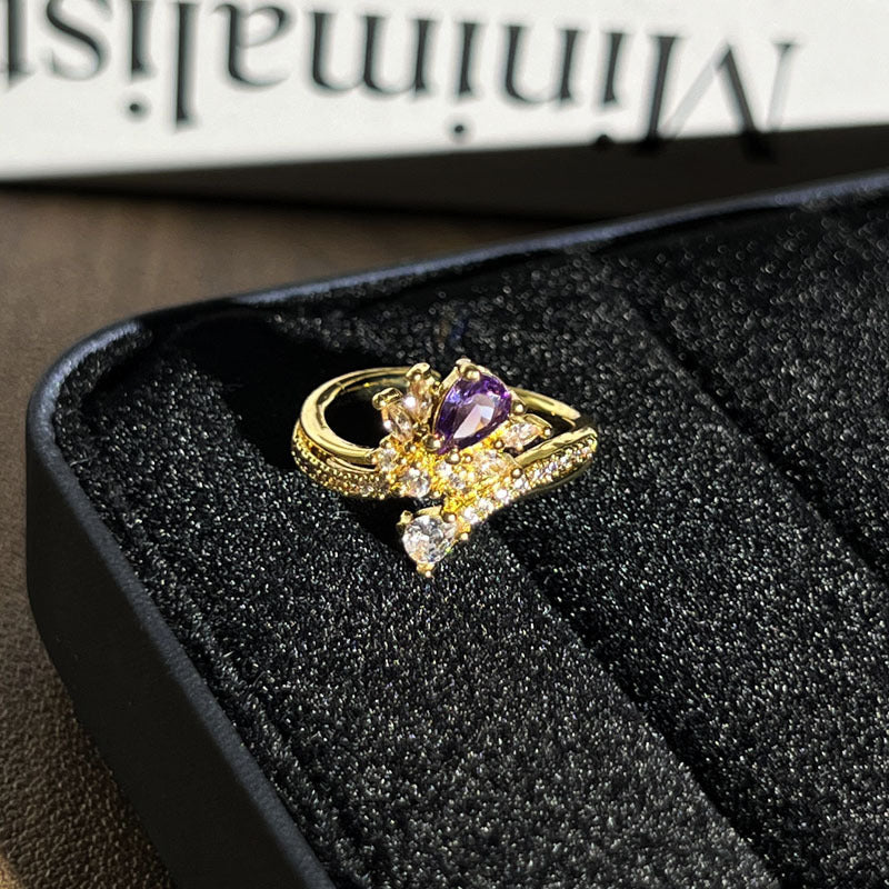 Close up of a retro-style geometric open ring with micro pave detail worn on a finger