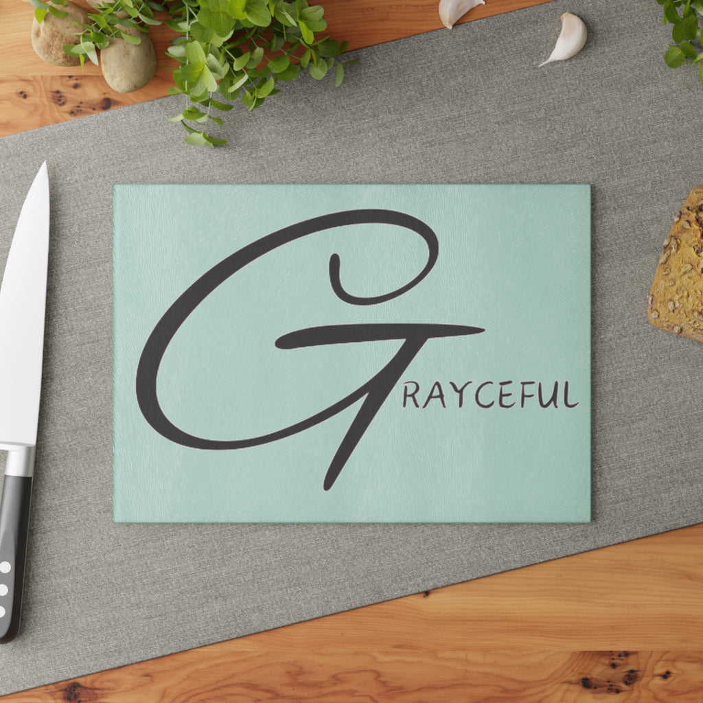 Signature glass cutting board measuring 8x11 inches on a kitchen countertop