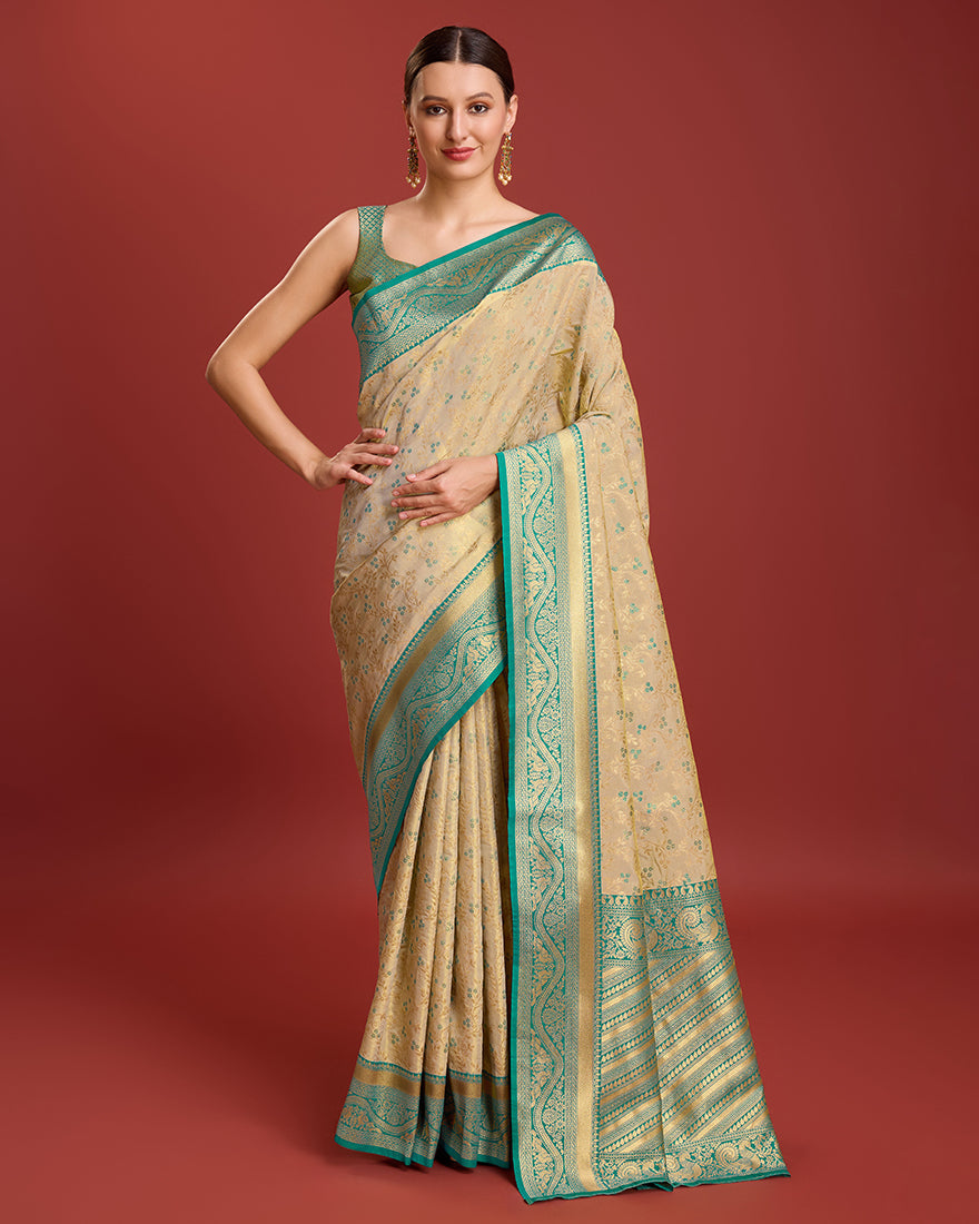 A beige zari woven Banarasi tissue silk saree with a premium, glowing finish.