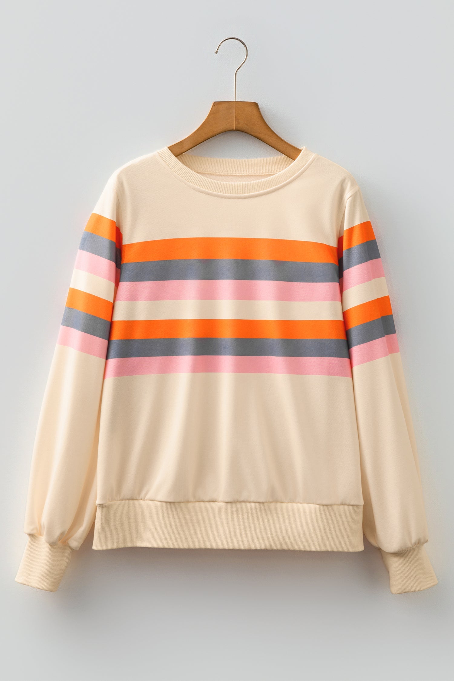 Women's cream pullover with orange, pink, and grey horizontal stripes and puff sleeves on a wooden hanger