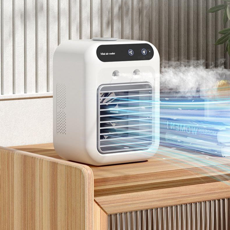 Portable water cooling fan on a desk, showing misting technology and ice-compatible compartment.