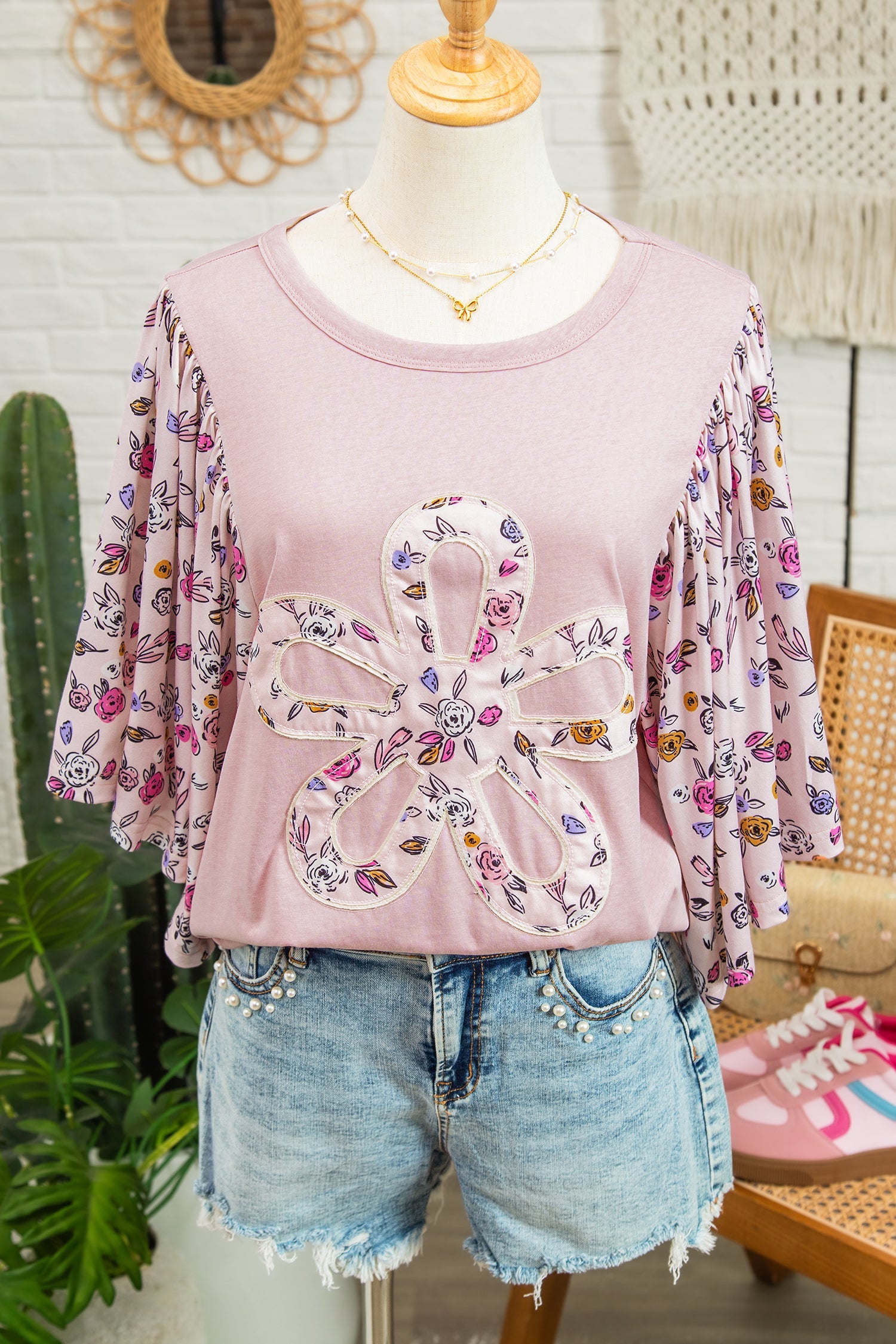 Pink floral patchwork blouse with flowy half sleeves, viewed from the front