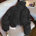 Women's Harajuku style black stand collar puffer jacket, seen from side on a chair.