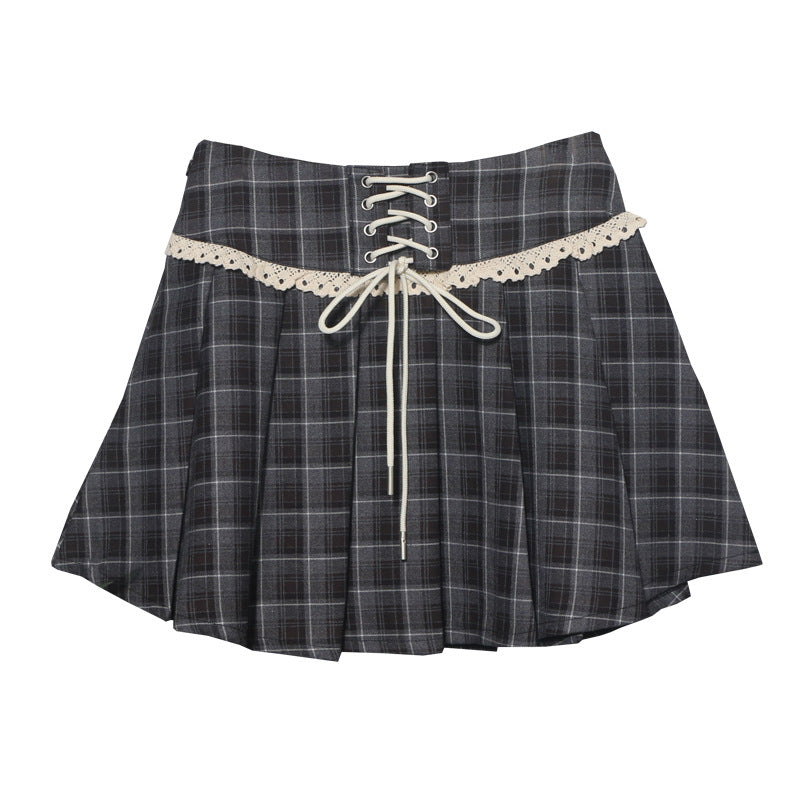 A checkered pleated mini skirt with a decorative lace-up front and delicate lace edge, shown in both gray plaid and brown plaid colors.