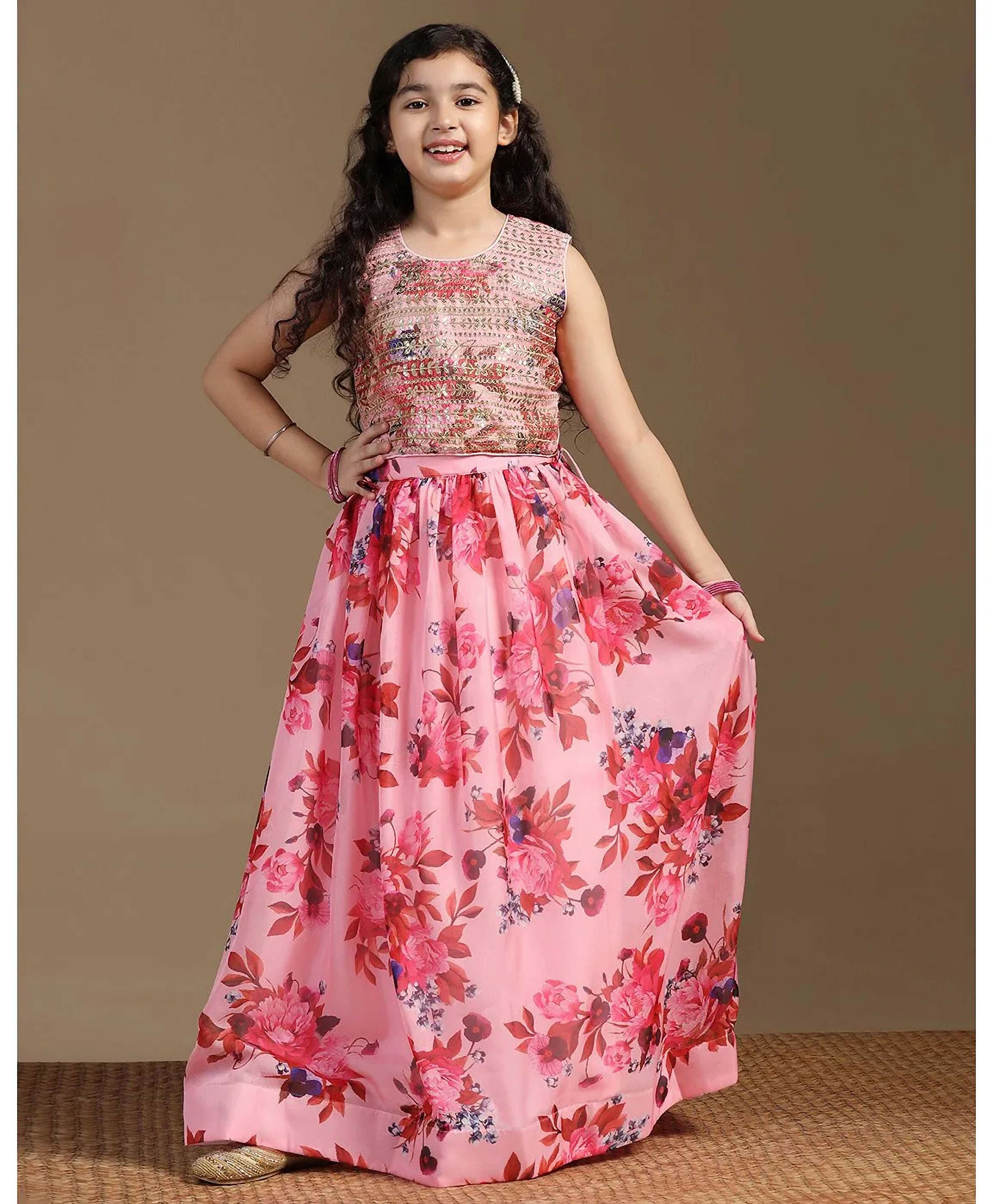 A vibrant peach girls lehenga choli made of tabby silk fabric