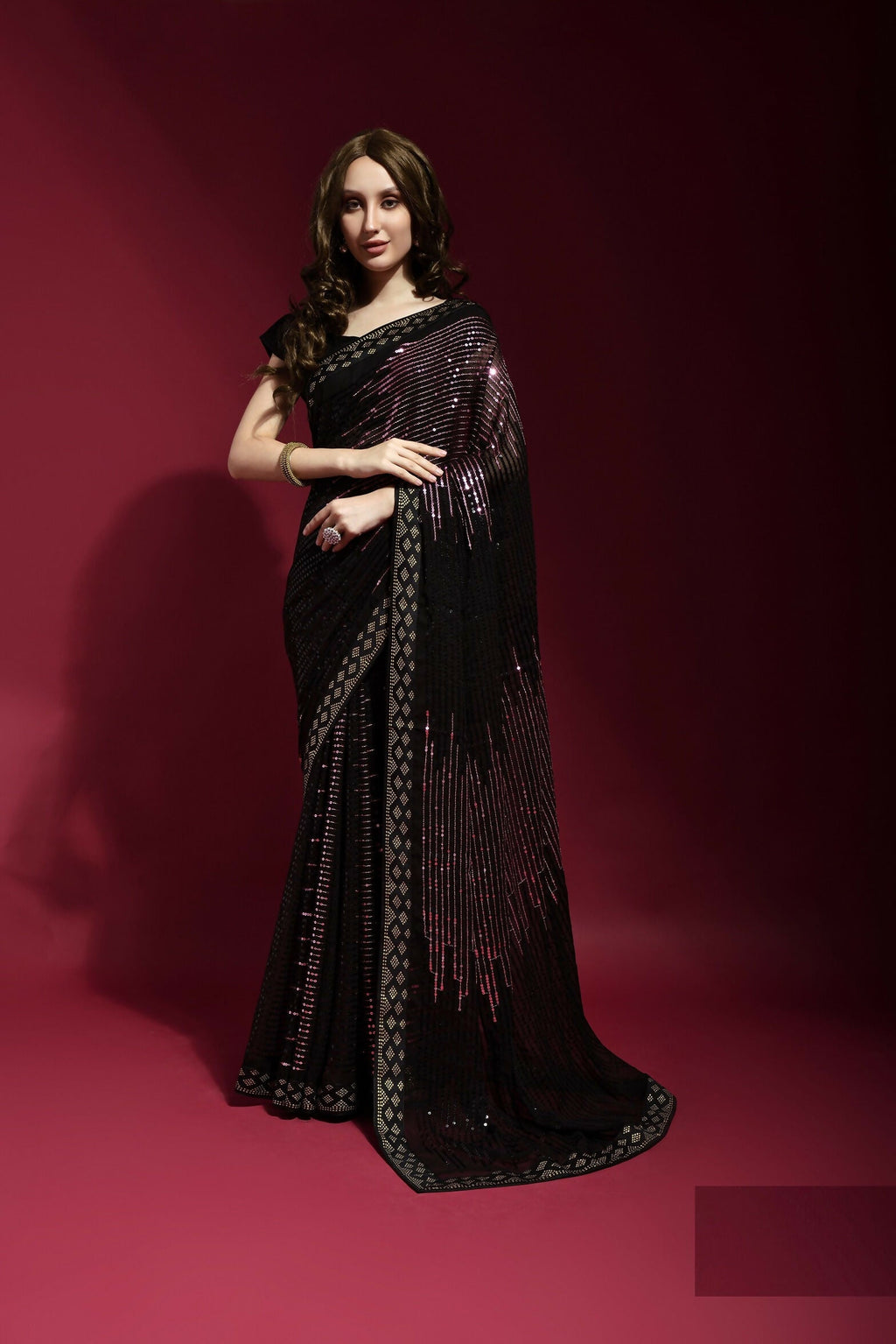 Model wearing a black georgette party wear saree with intricate embroidery