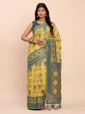 Yellow linen cotton saree with a distinct contrast green blouse piece.