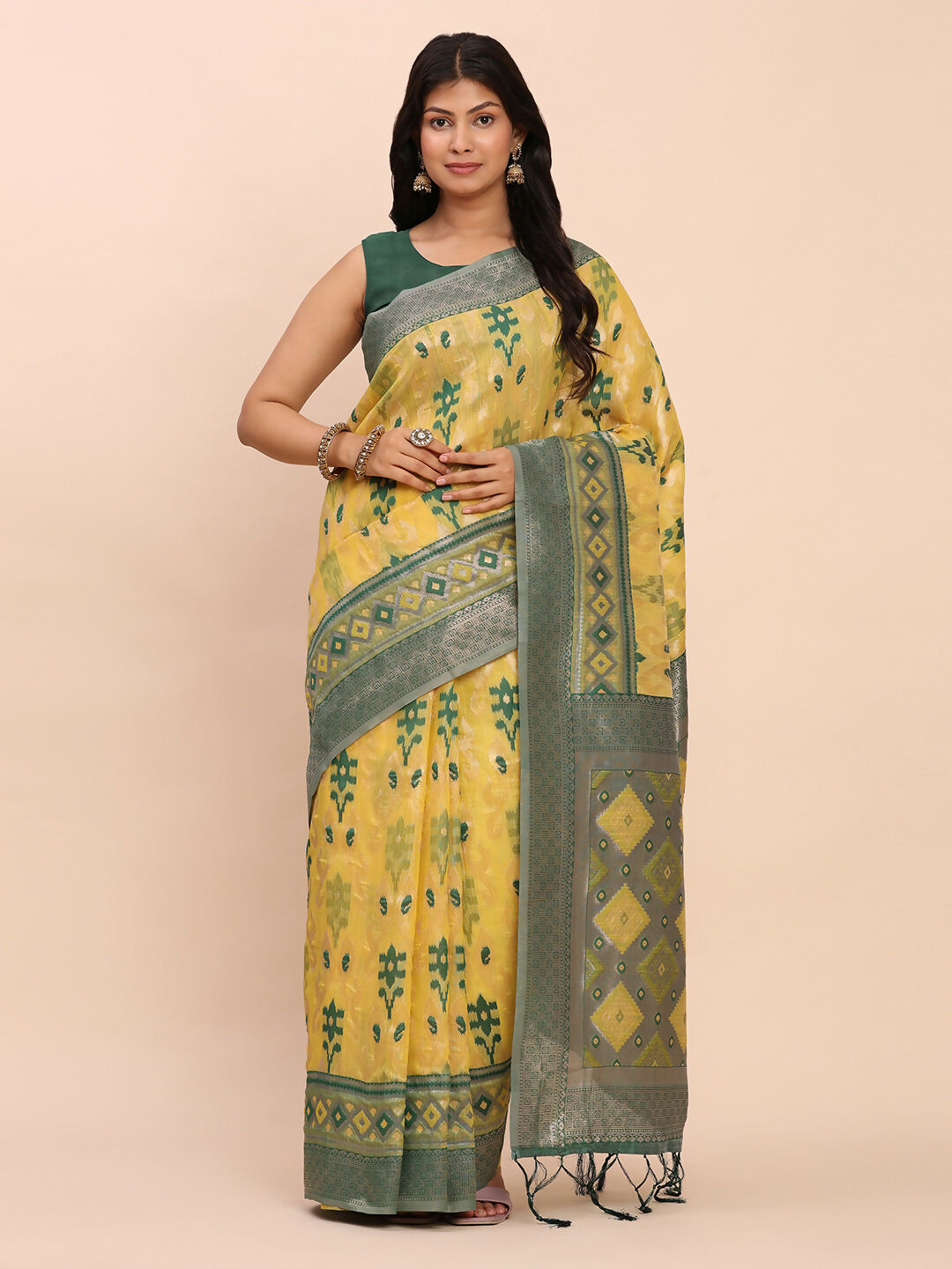 Yellow linen cotton saree with a distinct contrast green blouse piece.