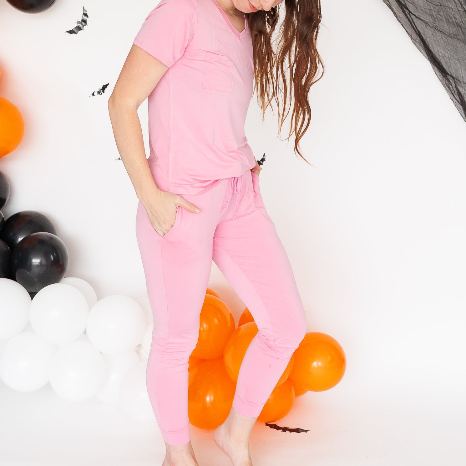 Model wearing a matching cotton candy pink bamboo short-sleeve top and jogger pant set