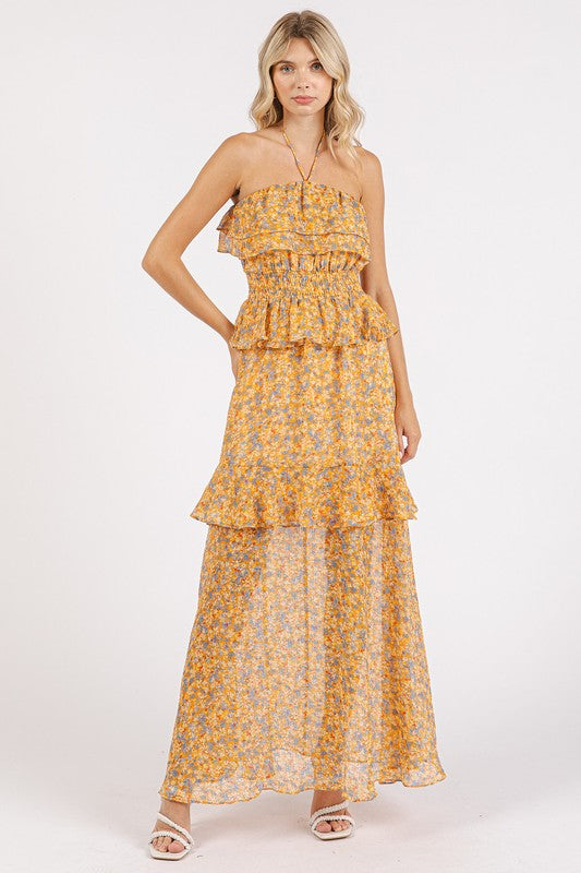 Elegant floral print maxi dress with a halter neckline and ruffled detailing.