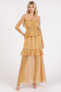 Elegant floral print maxi dress with a halter neckline and ruffled detailing.