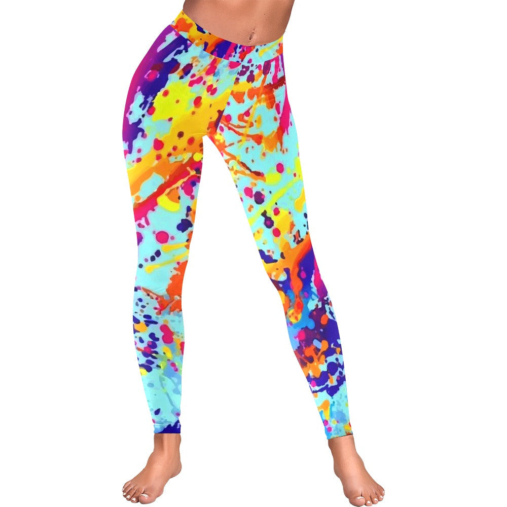 A model wearing Harajuku style women's low rise leggings with a vibrant, colorful paint splatter print in blue, yellow, orange, pink, and purple, shown from the front and side.