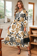 Model wearing a long sleeve V-neck dress with a patchwork earth-tone floral print and ruffled hem