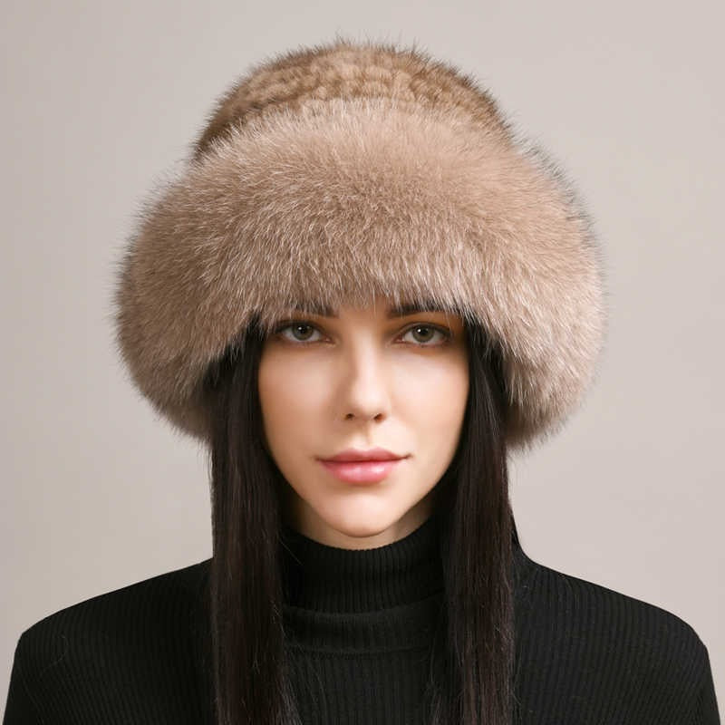 A woman wearing a luxurious beige braided mink-style fur winter beanie hat.