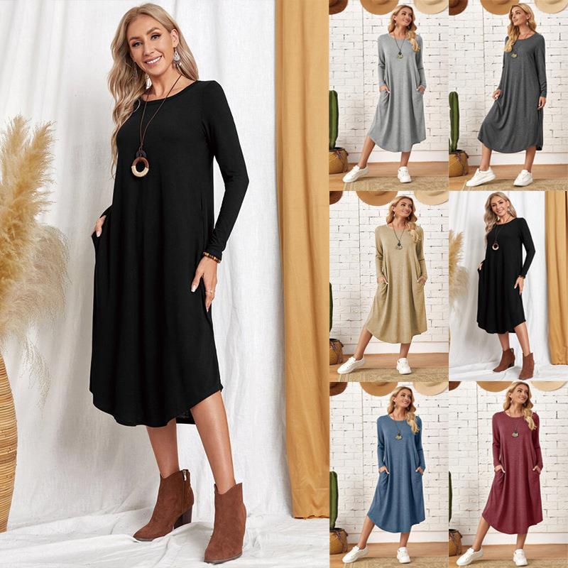 A woman wearing a long sleeve midi dress with pockets in a solid color, paired with casual boots.