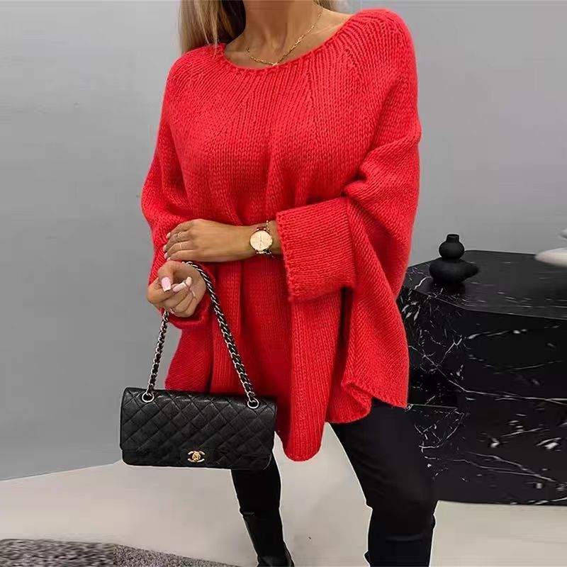 Woman wearing an oversized apricot batwing sleeve pullover sweater with a shawl-style neckline