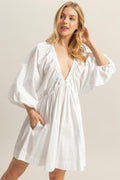 White poplin mini dress with a deep plunge neckline and voluminous balloon sleeves