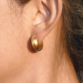 Polished chunky C hoop earrings made from stainless steel in a minimalist style