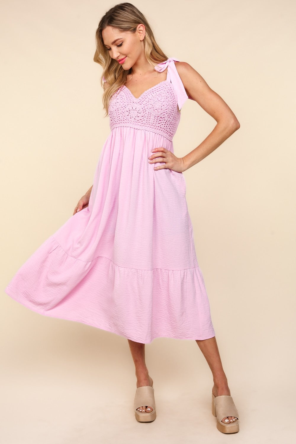 Elegant cami style midi dress featuring intricate crochet lace and a layered ruffle hem